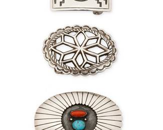 427
A Group Of Southwest Silver And Stone Set Buckles
Mid/late 20th century
Each unmarked
Comprising three buckles including a heavy sand-cast openwork concho buckle with internal star motif (2.5" H x 3.375" W), a coral and turquoise shadowbox set oval concho style buckle (2.75" H x 4" W). and a rectangular buckle with central set turquoise and geometric silver overlay (1.5" H x 2.75" W), 3 pieces
171.3 grams gross
Estimate: $700 - $900