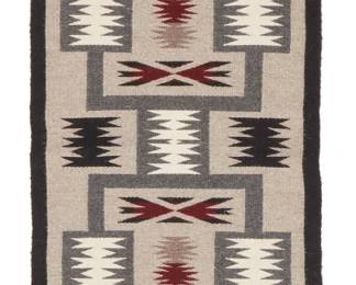 235
A Navajo Sampler/ Runner
Mid-20th century, Diné
A sampler-style runner woven in grey, black, cream, and red wool, with various geometric motifs in three panels
21" H x 75.5" W
Estimate: $500 - $700