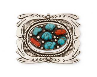 426
A Jessie Claw Navajo Reversible Belt Buckle
Jessie Claw (b. 20th century, Diné)
Late 20th century
Stamped: JC
A chunky chased and stamped silver buckle with central spinner featuring set coral and turquoise to one side and set turquoise verso
2.625" H x 3.25" W
172.9 grams gross
Estimate: $300 - $500