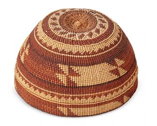 122
A Hupa/Yurok/ Karuk Polychrome Basketry Hat
Early 20th century; Northern California
The twined hat with imbricated red and brown banded stripe, sawtooth, and geometric motifs
3.75" H x 6.5" Dia.
Estimate: $400 - $600