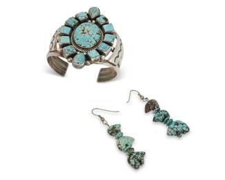394
A Group Of Fred Guerro Navajo And Southwest Turquoise Jewelry
Fred Guerro (b. 20th century-d., Diné)
Cuff stamped: Fred Guerro / Sterling
Comprising a large Fred Guerro chunky three-wire cuff with cluster set turquoise, together with a pair of associated carved turquoise graduated bear fetish earrings, 3 pieces
Cuff: 6.5" inner C x 1.75" H, with a 1.125" gap; each earring: 2.625" H
99.2 grams gross
Estimate: $500 - $700