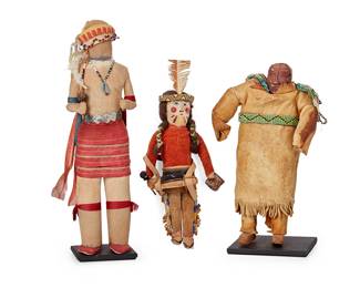 309
Three Southwest Dolls
Mid-20th century
Comprising a hide and carved polychrome wood doll with a band of beads around waist and webbed strand of beads to neck, a taller cloth-wrapped doll with metal waistband, adorned with beads around neck and head, which is mounted with feathers, and a shorter cloth-wrapped doll with hide and beaded elements around legs and head, depicted holding a small drum and mallet
3 pieces
Largest overall: 12.25" H x 3.5" W x 3" D
Estimate: $500 - $700