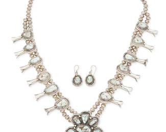 347
A Set Of Juan Abeyta Navajo Sterling Silver And Turquoise Jewelry
Juan Abeyta (b. 20th century, Diné)
Late 20th century
Naja stamped: J. Abeyta / Sterling
Comprising a chunky squash blossom necklace with a large set Dry Creek turquoise naja and twelve matching blossoms, with a pair of matching earrings, 3 pieces
Necklace: 28" L x 3" H; each earring: 1.5" H
246.3 grams gross
Estimate: $1,000 - $1,500