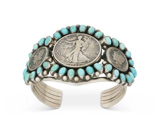 377
A Paul Livingston Navajo Sterling Silver Coin Cuff Bracelet
Paul Livingston (b. 20th century, Diné)
Mid/late 20th century
Stamped: Paul Livingston / Sterling
A five-wire sterling silver cuff with three central set coins edged with cluster/row set oval turquoise cabochons
6.375" total inner C x 2.125" H, with a 1" gap
85.1 grams gross
Estimate: $700 - $900
