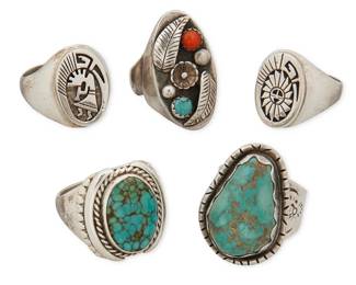454
A Group Of Southwest Sterling Silver Rings
Mid/late 20th century
Each marked for artist and for sterling: [salamander] / M / N [with circles] / CS
Comprising five large chunky rings including a Calvin Peterson Navajo/Diné storyteller ring, a silver kokopelli storyteller ring, and three further rings with set turquoise and coral, 5 pieces
Largest: ring size: 13.5; smallest: ring size: 11.5
103.1 grams gross
Estimate: $400 - $600