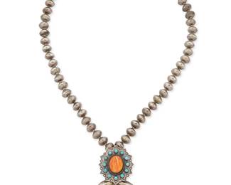 356
A Southwest Silver And Set Stone Necklace
Mid-20th century
Unmarked
A silver bead necklace finished with a sand cast naja pendant topped with an applied plaque with central set spiney oyster and cluster set turquoise
26" L x 3.75" H
175.4 grams gross
Estimate: $500 - $700