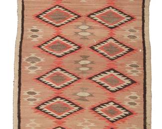 203
A Navajo Regional Runner
Early 20th century, Diné
Woven in red, pink, dark brown, tan, and natural grey/brown wool, with two columns of serrated diamonds and floating geometric motifs centering a simple line border
43.5" H x 87" W