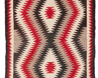 209
A Navajo Eyedazzler Rug
Mid 20th century, Diné
Woven in red, black, grey, and cream wool, with a conjoined diamond motif
60" H x 97.5" W
Estimate: $500 - $700