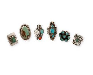 453
A Group Of Southwest Silver And Stone-Set Rings
Mid/late 20th century
One etched: Curley
Six silver rings in various sizes and styles including cluster-set and ketoh-style, as well as three bezel-set rings with variously shaped stones, one with heavy matrix, and a coral and turquoise ring with applied silver feather motif and stamped accents, 6 pieces
Largest: ring size: 6.25; smallest: ring size: 4
65.9 grams gross
Estimate: $400 - $600