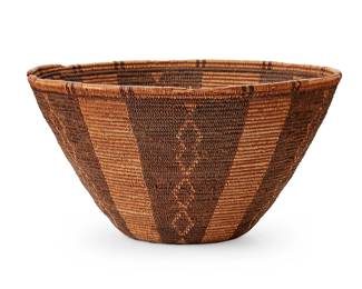 130
A Panamint Basket
Early 20th century; Central California
The finely woven coiled basket, possibly meant as a hat, with dark wide panels and columns of conjoined diamonds
4" H x 7.75" Dia.
Estimate: $400 - $600