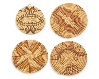 140
Four Hopi Pueblo Polychrome Basketry Plaques
Mid/late 20th century; Southwest United States
Comprising four trays/plaques, each with polychrome geometric motif, one depicting a tawa sun face with over-stitched embellishments
4 pieces
Largest: 14.25" Dia.; Smallest: 12.25" Dia.
Estimate: $400 - $600