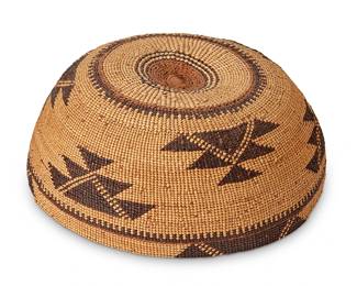 121
A Hupa/Yurok/Karuk Polychrome Basketry Hat
Early 20th century; Northern California
The twined hat with imbricated brown banded stripe and geometric motifs with orange accents
3" H x 7.25" Dia.
Estimate: $500 - $700