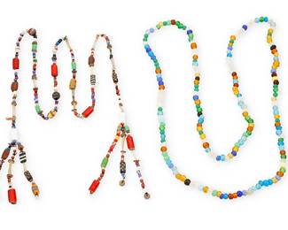 364
Two Trade Bead Necklaces
Early 20th century
Comprising a long strand of multicolored clear and opaque glass beads, including green, blue, yellow, black and clear (54" L), as well as a lariat-style bead necklace with tassel ends, with multiple bead styles, sizes, and colors including blown glass, shell, millefiori, and various ceramic beads (51" L), 2 pieces
Estimate: $500 - $700
