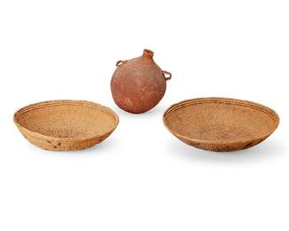 143
Three Basketry Items
Early 20th century
The twined basketry vessels, comprising two Latin American winnowing baskets, each with stenciled motifs to undersides, and an Apache water canteen with pine pitch sealant
3 pieces
Larger basket: 3.625" H x 15.375" Dia.; Canteen: 10" H x 8.5" Dia. approximately
Estimate: $300 - $500