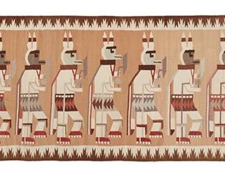 236
A Yei Pictorial Runner
Late 20th century
Signed in the weaving: PG
Possibly Pauline Glasses (b. 20th century, Diné), woven in red, ochre, cream, light brown, and dark brown wool, depicting eleven dancing figures centering an elaborate border
37.5" H x 113" W
Estimate: $400 - $600