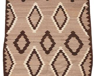 201
A Navajo Regional Rug
Early 20th century, Diné
Woven in natural grey, dark brown, and cream wool, with floating diamond motifs and stepped triangle border
60.5" H x 87" W
Estimate: $800 - $1,200