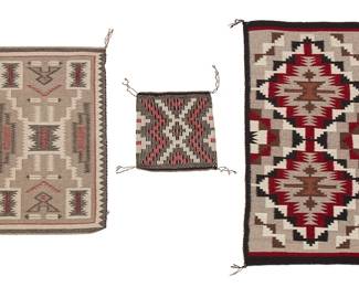 231
Three Navajo Weavings
Mid-20th century, Diné
Storm pattern with paper tag: Crownpoint Rug Weavers Association / Sally Mailboy / Burnt Corn; the small mat with vinyl tag: Genuine Navajo Rug / Marilyn Sloan
Comprising a Ganado double mat woven in browns, black, red, cream, and natural grey/brown wool (20.25" H x 39.75" W), a fine twill weaved storm pattern mat woven in red, black, cream, and grey wool, with feather motifs (19.75" H x 31" W), and a small twill weave matt woven in red, black, grey, and cream wool, with central stepped diamond and zig zag motifs (12.5" H x 13.25" W)
3 pieces
Estimate: $500 - $700