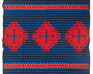 239
A Pendleton "Hubbell Trading Post Edition" Blanket
1980s
Edition: 413/1000
Numbered to graphic Hubbell Trading Post National Historic Site tag; With Pendleton cloth tag; also with original bi-fold paper tag with original plastic fastener: Pendleton Indian Blankets / A Warm and Colorful Heritage / Z494-172 / 82% filling (pure virgin wool) / 18% warp (spool spun cotton)
In the style of a Navajo Third Phase chief's blanket, the reversible blanket woven in red, blue, black, and grey wool, with central Spider Woman motifs centering stripes and banded motifs, housed in original box
Blanket: 64" H x 80" W; Box: 5" H x 21" W x 17.5" D
Estimate: $200 - $400
