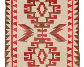 202
A Navajo Regional Rug
Early 20th century, Diné
A large rug woven in red, cream, and dark brown wool with an elaborate hooked conjoined diamond motif and double border
54" H x 83.5" W
Estimate: $800 - $1,200