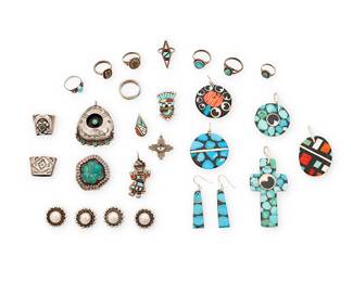 483
A Group Of Southwest Silver And Set Stone Jewelry
Mid/late 20th century
Two stamped: Sterling; further variously stamped: JP / _W_ / Sybil Cachini / E.C.K. / G.B. Natachu / SM / ATM
A large group comprising five multistone chip inlay pendants and a pair of earrings, two silver and set turquoise pendants, as well as four Zuni diminutive silver and stone inlay pendants, together with two silver scarf rings, four silver buttons, and eight stone set rings, 27 pieces
Largest pendant: 3" H; smallest: 1" H; Ring sizes: 7 to 1.75; each button: 0.75" Dia.
93.9 grams gross
Estimate: $300 - $500