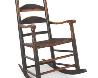 149
A Shaker-Style Carved Wood Rocking Chair
Early 20th century
The chair featuring a woven seat, with a formed ladder back surmounted by turned finials, issuing curvilinear arms supported on turned posts above double medial stretchers and raised on rockers
43" H x 23.5" W x 33" D
Estimate: $300 - $500