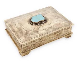 190
A J. Alexander Silver Alloy And Turquoise "Stamped Bible Box"
Early 21st century
Incised to underside: [tee pee cipher] / J. Alexander
The hammered and antiqued silver, copper, and nickel alloy trinket box with chased Navajo-inspired geometric designs, featuring a turquoise-mounted lid revealing a velvet-lined interior
4" H x 11.25" W x 8" D
Estimate: $600 - $800