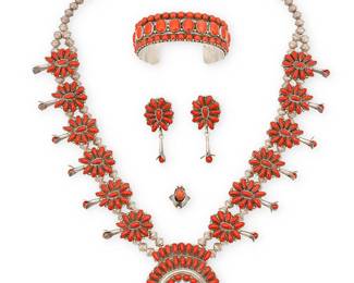 350
A Group Of Southwest Navajo Sterling Silver And Coral Jewelry
Late 20th century
Four works:

A set of Paul Jones Navajo sterling silver and cluster-set petit point coral jewelry
Paul Jones (b. 20th century, Diné)
Each stamped: P. Jones / Sterling [script]
Comprising a Zuni-style squash blossom necklace with twelve cluster set blossoms and a central naja, and a pair of matching earrings, 3 pieces
Necklace: 26" L x 2.5" H; each earring: 2" H

A Lester James Navajo sterling silver and set coral cuff bracelet
Lester James (b. 20th century, Diné)
Stamped: L. James / S/S [script]
A chunky cuff with round and oval row-set coral cabochons and silver ball accents
6.875" inner C x 1" H, with a 1.375" gap

A Southwest set coral and silver ring
Stamped: MW
A small ring with oval coral cabochon and applied silver feather motifs
Ring size: 3.75

5 pieces total
208.9 grams gross
Estimate: $800 - $1,200