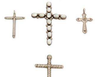 467
A Group Of Southwest Style Silver Cross Pendants
Mid/late 20th century
One marked: Sterling
Four silver cross pendants in various designs and styles including a large pendant with set white stone cabochons, and a smaller stamped sterling silver cross, together with a diminutive pair of pierced earrings, 6 pieces
Largest: 2.75" H x 2" W; smallest: 1.625" H x 1" W; earrings: 0.375" H
39.5 grams gross
Estimate: $200 - $300
