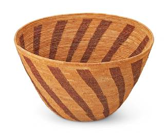 133
A Yokuts Basket
Early 20th century; Central California
The large coiled basketry bowl with radiating spiraled vertical brown/red columns
9.5" H x 16" Dia.
Estimate: $1,800 - $2,200