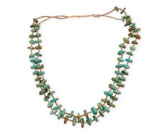337
A Southwest Pueblo Turquoise Necklace
Mid/late 20th century
A double-strand necklace of chunky turquoise tabs separated by heishi shell spacers and with a wrapped neck cord
29" L
Estimate: $500 - $700