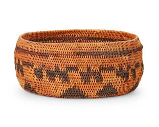 129
A Central California Basket
Early 20th century; California
The coiled basketry wide bowl with a banded stripe above banded figures and triangle motifs
2.5" H x 6.125" Dia.
Estimate: $500 - $700