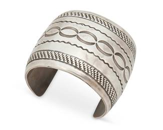 404
A Southwest Silver Cuff Bracelet
Mid-20th century
Unmarked
A chunky double-walled cuff with multiple bands of stamped motifs
6.5" inner C x 2.125" H, with 1.5" gap
136.5 grams
Estimate: $400 - $600