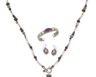 470
A Group Of Southwest Sterling Silver And Sugilite Jewelry
Late 20th/21st century
Each marked for sterling; three further marked for artist
Three works comprising an Albert Jake (b. 1959, Diné) Navajo wire wrapped cuff bracelet with central set oval sugilite, as well as a silver Aldrich inlaid stone cross pendant suspended from a sterling silver and multistone Peyote Bird Designs necklace, with a pair of similar design earrings with sugilite and opal inlay, 5 pieces
Cuff: 6.25" inner C x 0.5" H, with 1" gap; pendant: 2.25" H x 1.5" W; necklace: 36" L; earrings: 1.5" H
165.6 grams gross
Estimate: $500 - $700