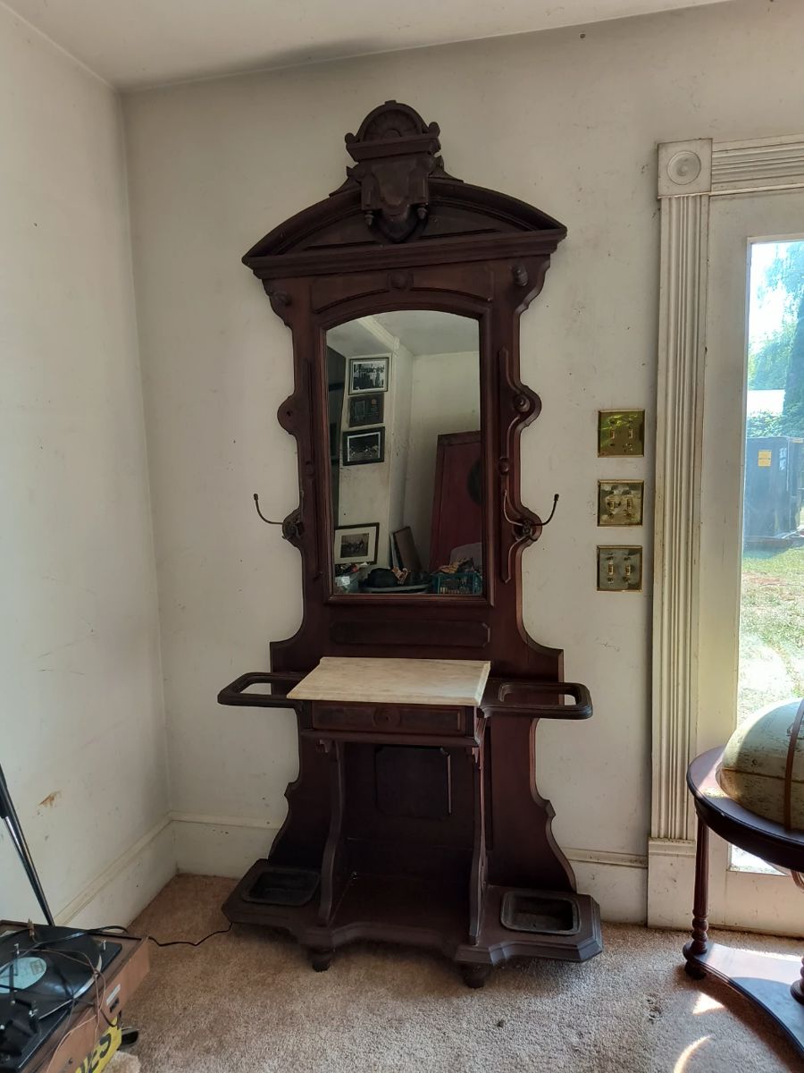 Antique spectacular hall tree with marble table top and cast iron drip trays.  There are 2 other hall trees.