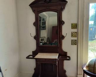 Antique spectacular hall tree with marble table top and cast iron drip trays.  There are 2 other hall trees.