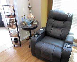 Duel power black leather recliner w/ cupholders and armrest storage. Also includes LED lighting and a USB connection.  ** Antique round top end table w/ glass protective top. Metal corner accent shelf.
