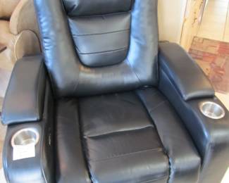 Black leather electric recliner with cup holders and arm storage
