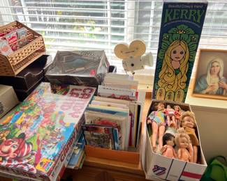 This picture shows several dolls and a couple of children's board games.  Like Gremlins?  AMC Gremlins?  There is a model (or at least the box).