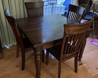 This is a wonderful small square table with four matching chairs.  This will look wonderful in your house.