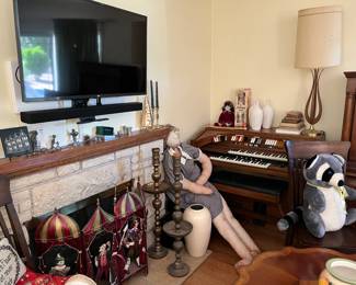 The flat-screen TV and stereo bar shown here is NOT FOR SALE.  In the corner is an electric organ; these are not in sales too often.  Watching guard on the organ is a life-sized stuffed grandmother, but the fireplace screen is a highlight! 