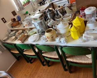 This is a better look at the four green chairs with wicker seats.  Of course, there are also lots of kitchen appliances, utensils, and service pieces.