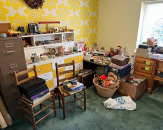 There are several items here, including two matching chairs, a filing cabinet, the yellow and white chest of drawers and shelves, a wooden desk (partially seen on the right), and lots more!