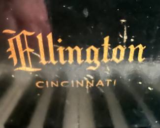 The baby grand piano is made by Ellington, as this picture shows.  