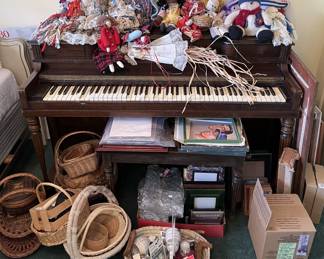 Underneath all the dolls here there is a spinet piano, but several of the keys are stuck.  If you are looking for a prop or want to restore it, this is the one.  Don't forget the baskets.