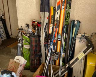 There are a few pairs of snow skis and poles, as well as golf clubs.  