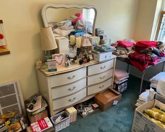 This six drawer dresser with mirror is a wonderful piece.  Of course, there are lots of smaller items around it.  Look at the table on the right, with lots of blankets.
