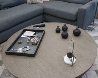 Antoccino 48 " round coffee table. The only items on the table that are for sale are the 4 weights from Restoration hardware.