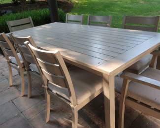 * Table on patio with 8 chairs. The cushions come off. It is made by Yard bird. The size is 40 3/4" x 86".