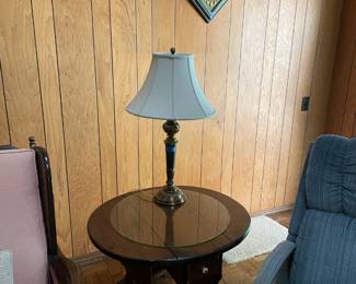 Table, lamp, and kitschy diamond shaped wall art.