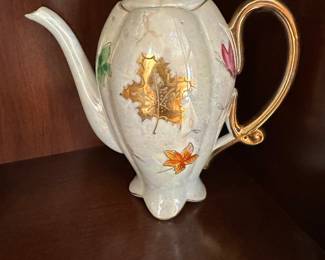 Vintage tea pot with gold leaf tea leaves